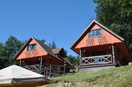 a large wooden house with a tent in front of it at Chata Wuja Toma in Szczyrk