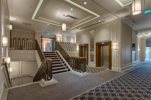 a lobby with a staircase in a building at Courthouse Hotel Shoreditch in London