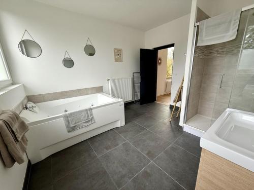 a bathroom with a tub and a shower and a sink at Le Calais Wilson 7 - Studio Balneo 2p in Calais