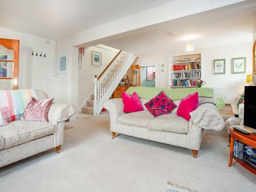 a living room with two couches and a staircase at Tean in Polruan