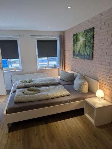 a bedroom with two beds and a brick wall at Stadtnah an der Förde 5501 in Flensburg