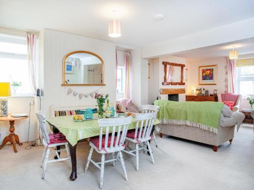 a dining room with a table and chairs at Tean in Polruan