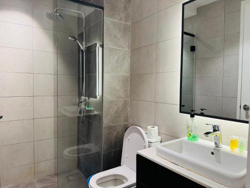 a bathroom with a shower and a toilet and a sink at Axon Residence KL in Kuala Lumpur