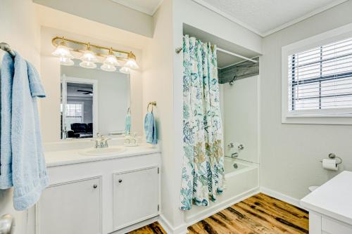 a bathroom with a sink and a mirror at Ultimate Canal Front Game Room Boat Ramp in Crystal Beach