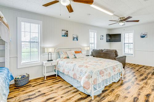 a bedroom with a bed and a ceiling fan at Ultimate Canal Front Game Room Boat Ramp in Crystal Beach