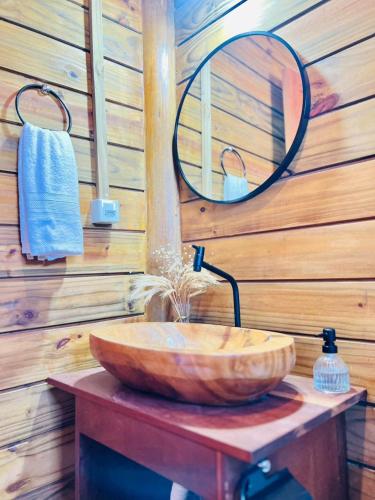 a wooden bathroom with a sink and a mirror at Chalet Paraiso Canoa 3 na praia - Canoa Quebrada in Aracati