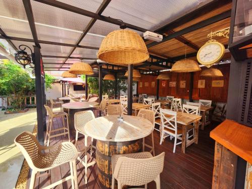 a restaurant with tables and chairs and a clock at The Rustic Residence - Fine Culinary Experience - TRR6 in Pointe aux Canonniers