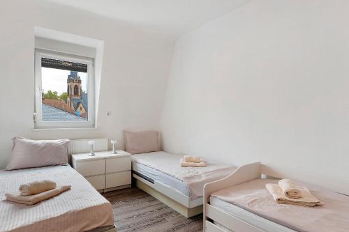 a room with two beds and a window at Az-Living Feudenheim in Feudenheim