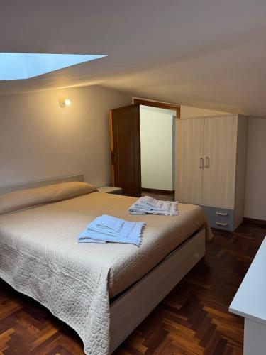 a bedroom with a bed with two towels on it at A Casa di Micol in Poggio Mirteto