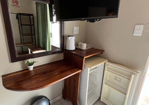 ルンドゥにあるNgandu Hotel - Runduの小さなキッチン(シンク、鏡付)