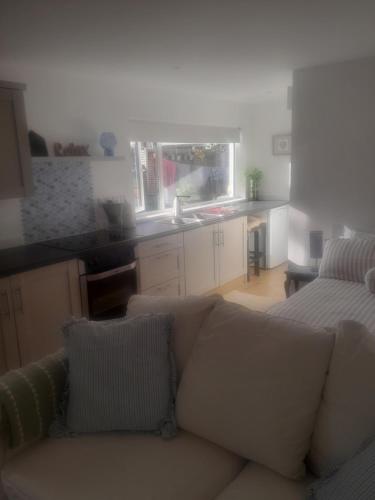a living room with a couch and a kitchen at Claire in Banbridge