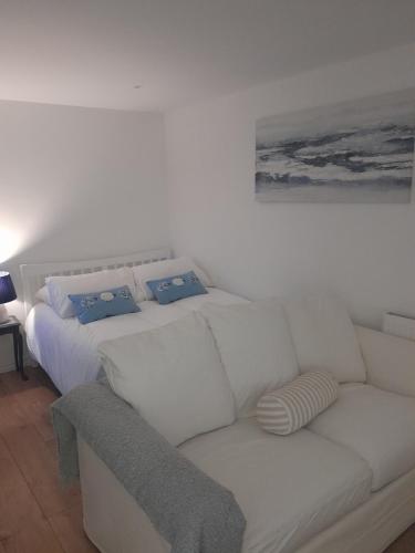 a white couch in a living room with a bed at Claire in Banbridge