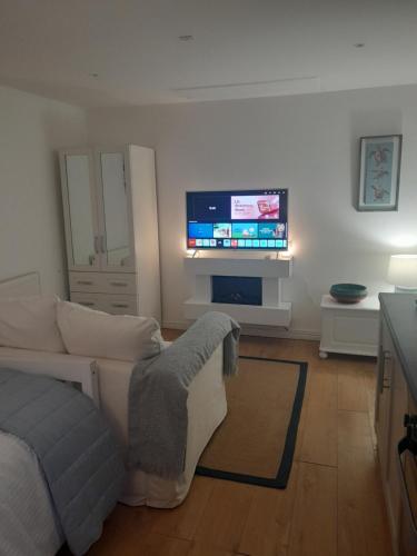 a living room with a couch and a flat screen tv at Claire in Banbridge