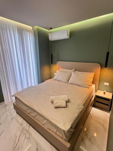 a bedroom with a bed with a towel on it at Sunset Luxury Apartment Shengjin in Lezhë