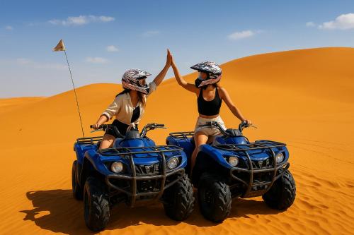 two people riding on atvs in the desert at Desert Dream Apartment in Merzouga