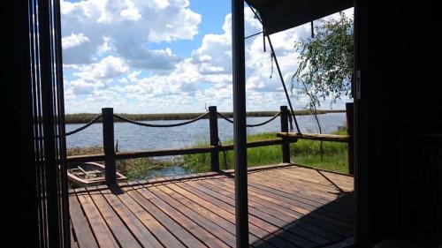 a view of a porch with a view of the water at Proudly Okavango self-catering Burnside in Shakawe