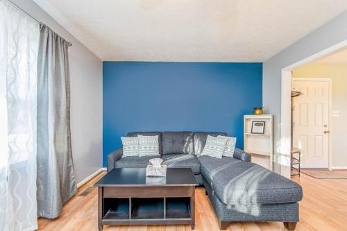 a living room with a couch and a blue wall at Reilly Road Refuge in Fort Bragg