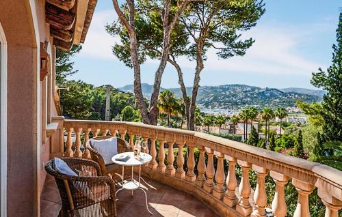 a balcony with chairs and a table with a view at Villa Son Max in Port d’Andratx
