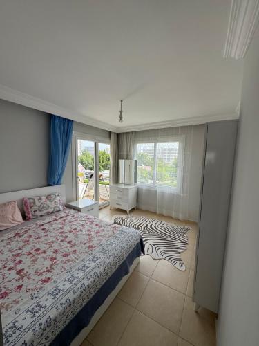 a bedroom with a bed and a zebra rug at Villa Martin Mersin in Mezitli