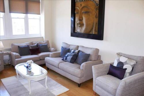 a living room with two couches and a table at The Palm Suite in Southport