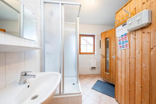 a bathroom with a sink and a shower at Chalets am Feuerkogel - LANDLUFT in Ebensee