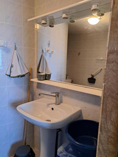 a bathroom with a sink and a toilet and a mirror at Studio sur les hauteurs de La Ciotat vue mer in La Ciotat