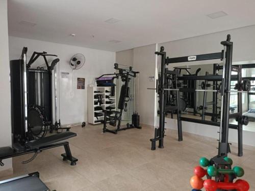 a gym with several tread machines in a room at Apartamento Familiar - Casa Da Madeira in Caldas Novas