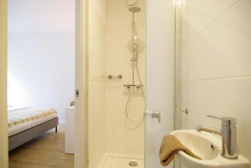 a bathroom with a shower and a sink at spacious new appartment in Lisse