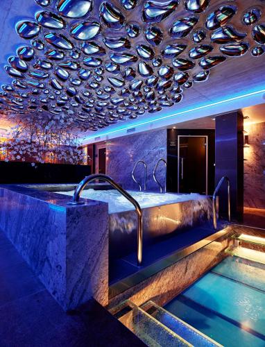 a bathroom with a bath tub and a sink at Theatre Hotel in Olomouc
