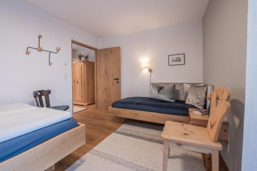 a small bedroom with a bed and a table at BioTop Appartement Kronplatz in Perca