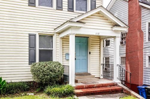 a white house with a blue door at The Woodside Guest House in Fayetteville