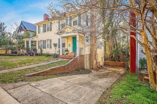 a large white house with a tree in front of it at The Woodside Guest House in Fayetteville