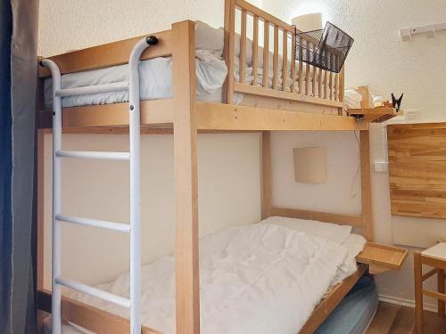 a bunk bed with a ladder next to a bunk bed at Appartement skieurs, accès direct pistes, balcon sud, proche remontées - FR-1-518-109 in Val dʼIsère