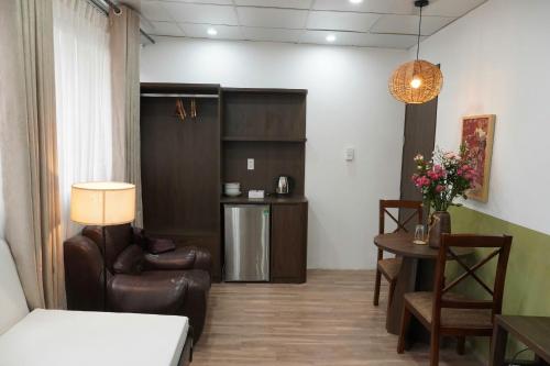 a living room with a couch and chairs and a table at Cốm Homestay in Hanoi