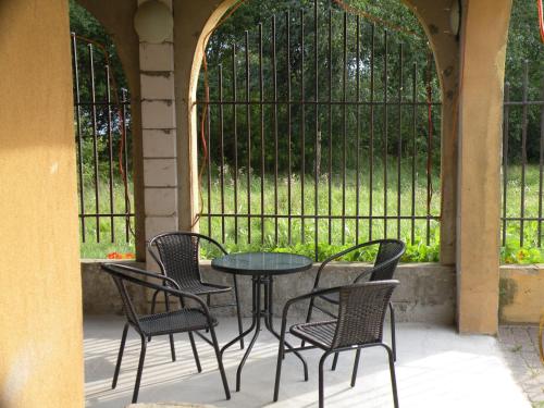 a patio with a table and chairs in front of a gate at Arkady in Słupsk