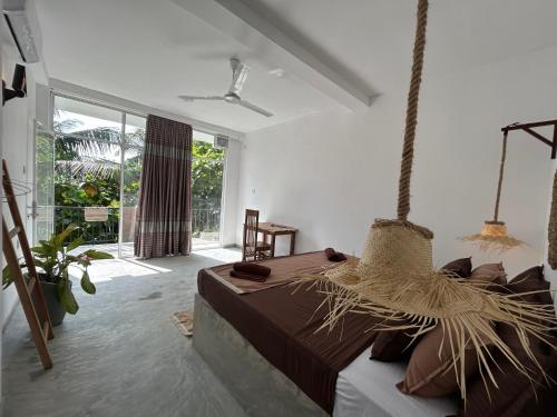a bedroom with a bed in a room at Bananas Mirissa in Mirissa