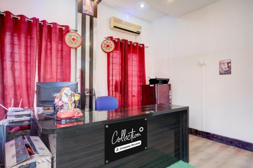 a counter in a room with red curtains at Collection O GNRC Hospital Dispur Formerly Shree Vinayak Guest House in Guwahati