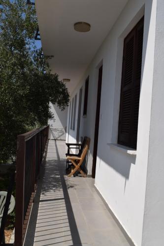 a porch of a house with a bench on it at Lasa Heights Hotel in Lasa