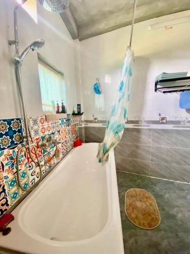 a bathroom with a bath tub and a shower at Ha Giang Uphill Coffee Farmstay in Ha Giang