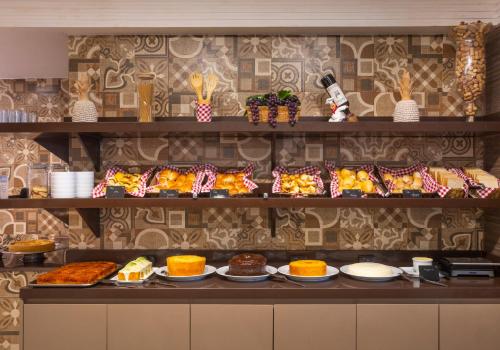 a buffet with many different types of food on display at Atlântico Praia Hotel in João Pessoa
