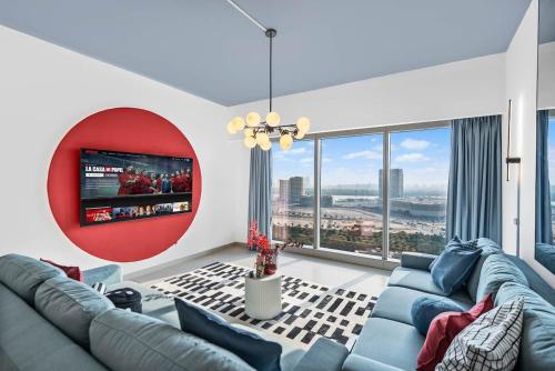 a living room with blue couches and a flat screen tv at Luxury Gate Tower Residence in Abu Dhabi