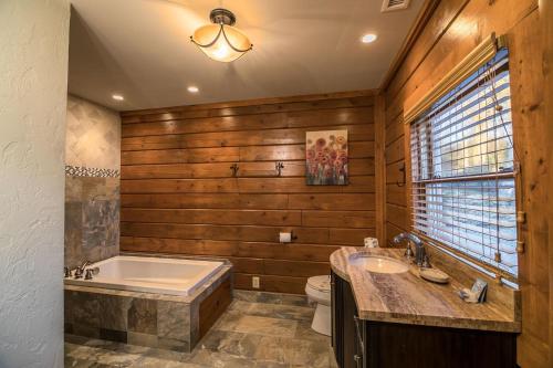 a bathroom with a tub and a toilet and a sink at Alpine Vista in Blowing Rock