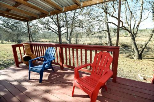 two chairs sitting on the deck of a porch at Kay's River Escape in Utopia