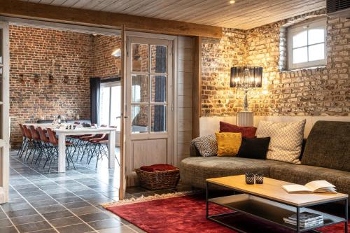a living room with a couch and a table at Vakantiehoeve Amadee in Zonnebeke
