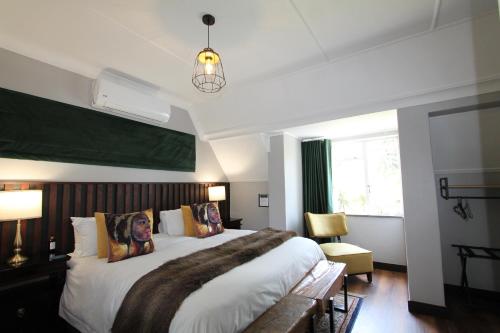 a bedroom with a large bed and a window at Wild Tree Lodge in Benoni