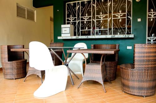 a group of chairs and tables in a restaurant at Go Culture Africa in Entebbe