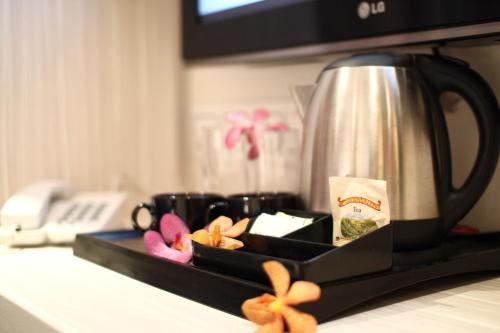 a tray with a coffee pot in a microwave at Venus Boutique Hotel in Melaka