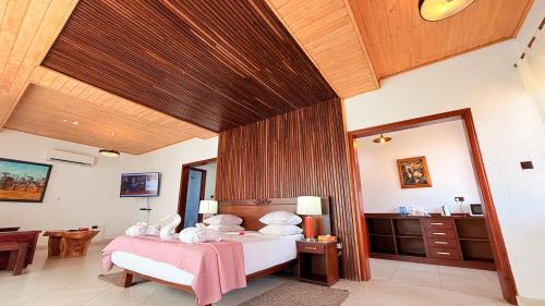 a bedroom with two beds in a room at Coconut Grove Beach Resort in Elmina