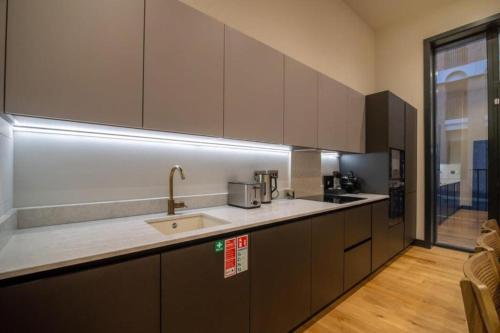 a kitchen with a sink and a counter top at Bauhaus by The Heim in Manchester