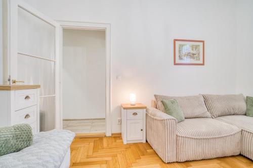 a living room with a couch and a chair at Charming Downtown Apartment in Otilia